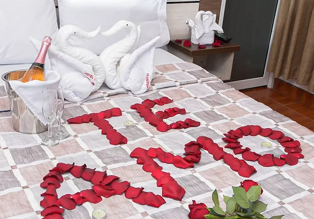 cuarto decorado formando la palabra te amo con petalos de rosas